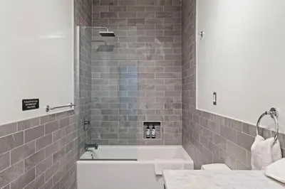 a bathroom with a bath tub and a sink at The Founders Suite Residence in Philadelphia