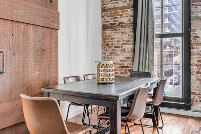 a dining room with a wooden table and chairs at The Founders Suite Residence in Philadelphia