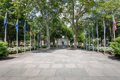 a walkway with flags in a park at The Founders Suite Residence in Philadelphia