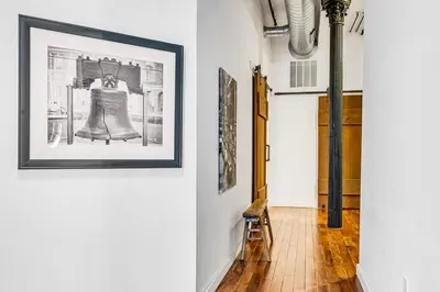 a hallway with a picture of a bell on the wall at The Founders Suite Residence in Philadelphia