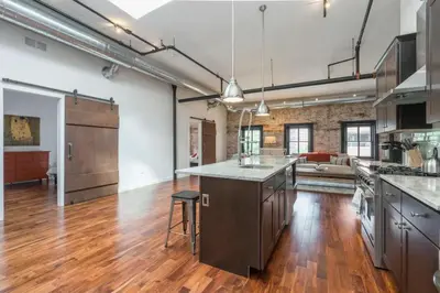 an open kitchen and living room in an apartment at The Liberty Suite Residence in Philadelphia