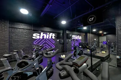 a gym with several cardio machines in a room at The Liberty Suite Residence in Philadelphia