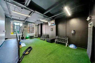 a room with a baseball bat and a green carpet at The Liberty Suite Residence in Philadelphia