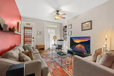 a living room with two couches and a flat screen tv at Fairmount Neighborhood Gem in Philadelphia