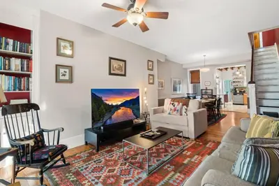 a living room with a couch and a tv at Fairmount Neighborhood Gem in Philadelphia