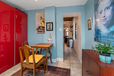 a dining room with a table and a red wall at Fairmount Neighborhood Gem in Philadelphia