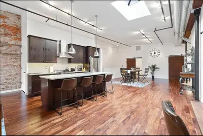 an open kitchen with a bar and a dining room at The Heritage Suite Central Old City Near the Liberty Bell in Philadelphia