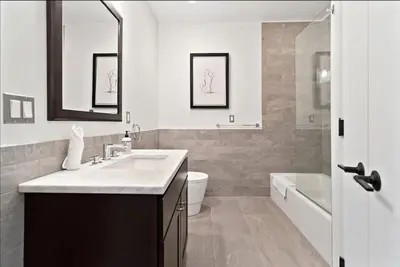 a bathroom with a sink and a toilet and a tub at The Heritage Suite Central Old City Near the Liberty Bell in Philadelphia