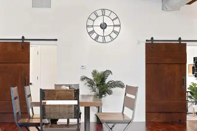 a dining room with a table and a clock on the wall at The Heritage Suite Central Old City Near the Liberty Bell in Philadelphia