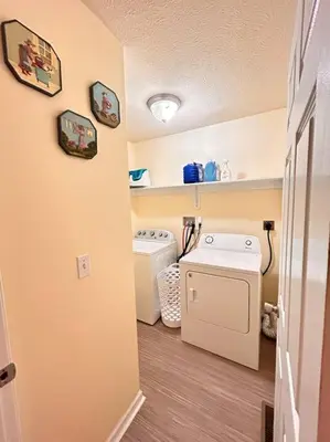 a laundry room with two washes and a washer at Modern 5 Bedroom Pocono house - Jacuzzi - Gameroom - Near Lake - Golf Couse in Tobyhanna