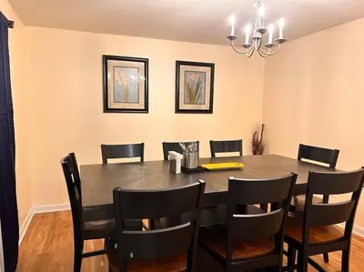 a dining room with a table and chairs at Modern 5 Bedroom Pocono house - Jacuzzi - Gameroom - Near Lake - Golf Couse in Tobyhanna