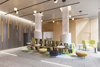 a lobby with colorful seating and tables and chairs at Home2 Suites By Hilton New York Times Square in New York