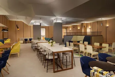 a dining room with tables and chairs at Hampton Inn by Hilton New York Times Square in New York