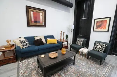 a living room with a blue couch and chairs at Downtown Easton in Easton