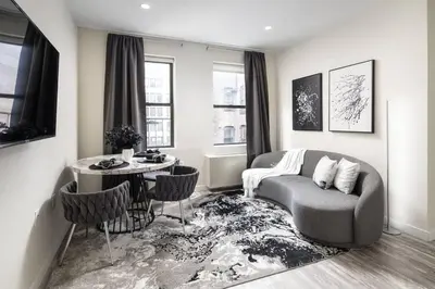 a living room with a couch and a table at Modern Spacious Apartment in Chelsea in New York