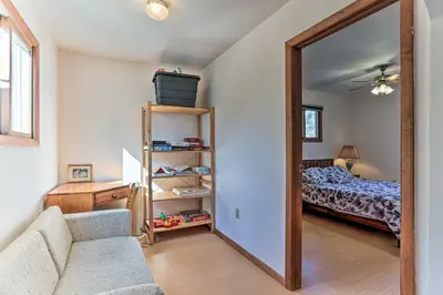 a living room with a mirror and a bed at Game Room, Fire Pit Family-Friendly Poconos Haven in East Stroudsburg