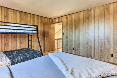 a bedroom with two beds and wooden walls at Game Room, Fire Pit Family-Friendly Poconos Haven in East Stroudsburg