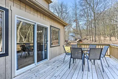 a wooden deck with a table and chairs on it at Game Room, Fire Pit Family-Friendly Poconos Haven in East Stroudsburg