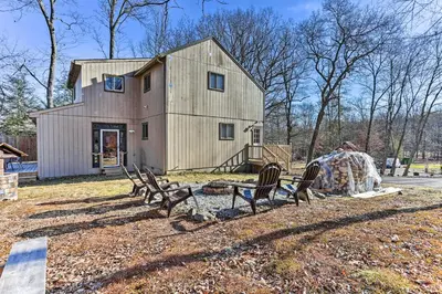 a group of chairs sitting in front of a barn at Game Room, Fire Pit Family-Friendly Poconos Haven in East Stroudsburg