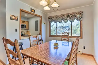 a dining room with a wooden table and chairs at Game Room, Fire Pit Family-Friendly Poconos Haven in East Stroudsburg