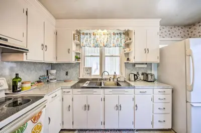 a kitchen with white cabinets and a sink and a refrigerator at Pet-Friendly Mohnton House Near Golf Course! in Mohnton