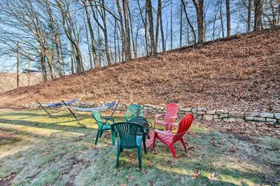 a group of four chairs sitting in the grass at Pet-Friendly Mohnton House Near Golf Course! in Mohnton