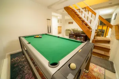 a pool table in the middle of a living room at Cozy Pocono Getaway In Arrowhead Lake in Thornhurst