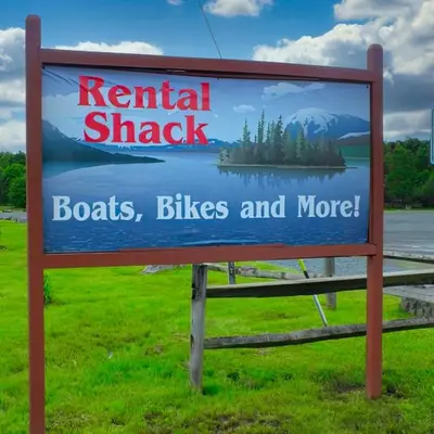 a sign for a rental shack with trees and water at Cozy Pocono Getaway In Arrowhead Lake in Thornhurst