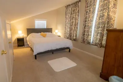 a bedroom with a bed and a window with curtains at Cozy Pocono Getaway In Arrowhead Lake in Thornhurst