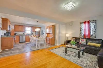 a living room and kitchen with a couch and a table at Deck and Grill Convenient Home in Hummelstown in Hummelstown
