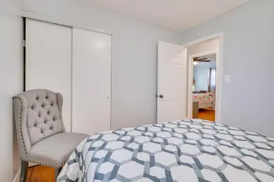 a bedroom with a bed and a chair at Deck and Grill Convenient Home in Hummelstown in Hummelstown