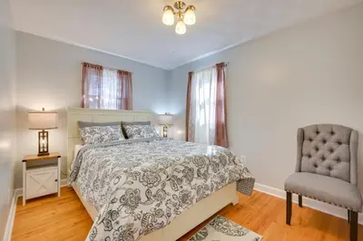 a bedroom with a bed and a chair at Deck and Grill Convenient Home in Hummelstown in Hummelstown