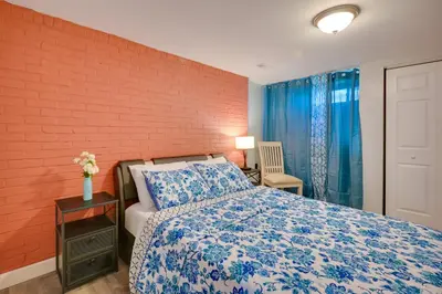 a bedroom with a bed and a brick wall at Deck and Grill Convenient Home in Hummelstown in Hummelstown