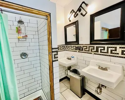 a bathroom with two sinks and a mirror at New York Spirit Retreats HOSTEL in New York