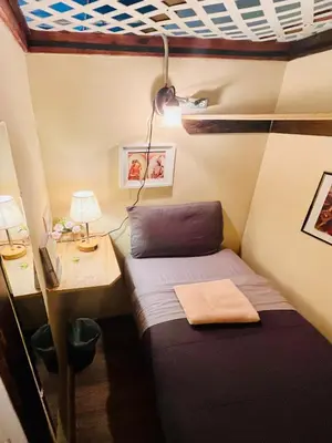 a small room with a bed and a desk at New York Spirit Retreats HOSTEL in New York