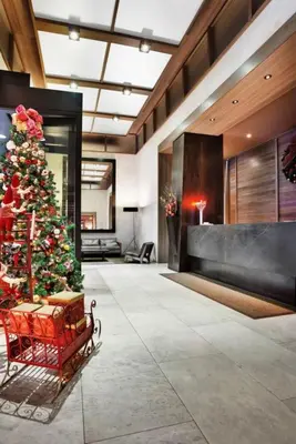 a christmas tree in the middle of a lobby at Rector Place in New York