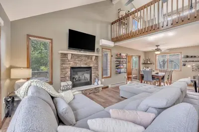 a living room with a couch and a fireplace at Steps To The Lake House, Hot tub, Game room, Deck in Albrightsville