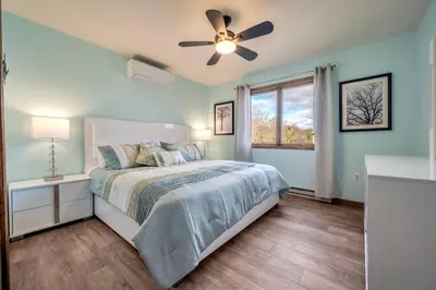 a bedroom with a bed and a ceiling fan at Steps To The Lake House, Hot tub, Game room, Deck in Albrightsville
