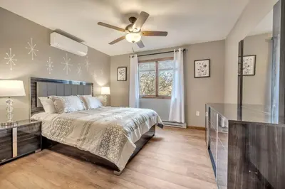 a bedroom with a bed and a ceiling fan at Steps To The Lake House, Hot tub, Game room, Deck in Albrightsville