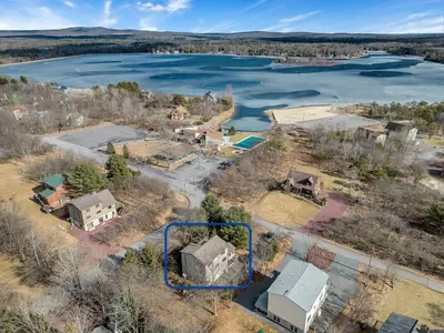 an aerial view of a house next to a lake at Steps To The Lake House, Hot tub, Game room, Deck in Albrightsville