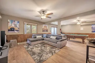 a living room with a couch and a pool table at Steps To The Lake House, Hot tub, Game room, Deck in Albrightsville