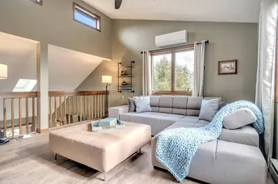 a living room with a couch and a table at Steps To The Lake House, Hot tub, Game room, Deck in Albrightsville