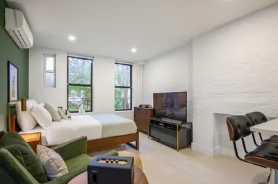 a bedroom with a bed and a tv in a room at E Village Studio w renovated virtual doorman NYC-316 in New York