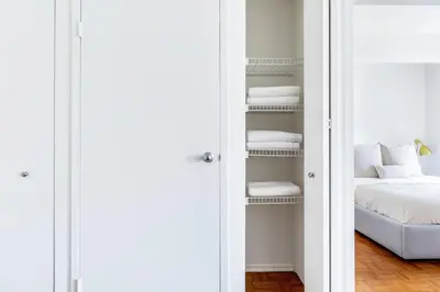 a room with a bed and a closet with towels at Chelsea 1BR w Gym nr Penn Station MSG NYC-528 in New York