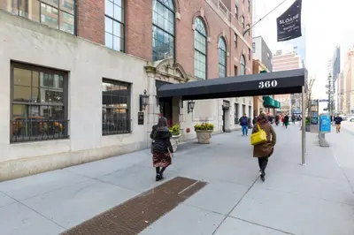 two women walking down a sidewalk in a city at Chelsea 1BR w Gym nr Penn Station MSG NYC-528 in New York
