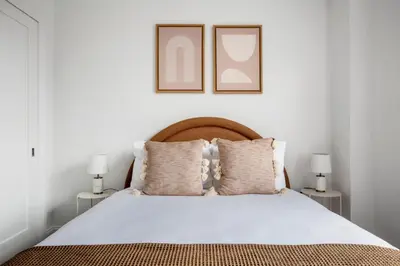 a bedroom with a white bed with two lamps at UWS 2br w elevator doorman gym nr Central Park NYC-952 in New York