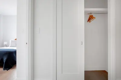 a room with white walls and a bed and a closet at UWS 2br w elevator doorman gym nr Central Park NYC-952 in New York
