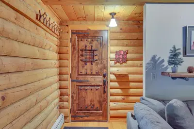 a room with a wooden wall with a door at Accord Vacation Rental with Pool and Hot Tub! in Accord