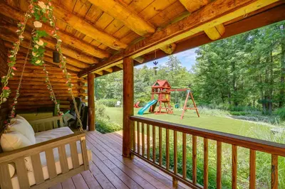 a porch with a swing and a playground at Accord Vacation Rental with Pool and Hot Tub! in Accord