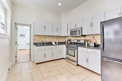 a kitchen with white cabinets and stainless steel appliances at Philadelphia Home Rental Near Center City! in Philadelphia